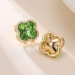 Clover crystal stud earrings with aquamarine cushion-cut center stone, micro-pave halo setting, and 925 sterling silver posts.