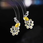 Peacock CZ crystal stud earrings featuring pear-cut body stone and colorful teardrop feather CZ accents with 925 sterling silver posts.