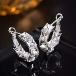 Half-hoop earrings channel-set with square emerald-cut AAA cubic zirconia stones, available in clear silver, aqua blue, and peridot green options.