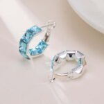 Half-hoop earrings channel-set with square emerald-cut AAA cubic zirconia stones, available in clear silver, aqua blue, and peridot green options.
