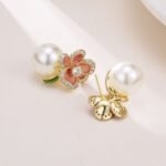 Enamel flower pearl stud earrings featuring micro-paved CZ petal borders, center round stone, glossy pearl drop, and 925 sterling silver ear posts