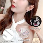 Sculpted peacock-shaped stud earrings set with vibrant pear-cut cubic zirconia stones and pavé feather details, available in emerald green, rose pink, and sapphire blue options.