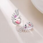 Sculpted peacock-shaped stud earrings set with vibrant pear-cut cubic zirconia stones and pavé feather details, available in emerald green, rose pink, and sapphire blue options.