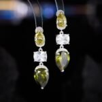 Three stone CZ drop dangle earrings featuring a pear-cut top stone, clear cushion-cut center, and teardrop bottom gem with 925 sterling silver posts