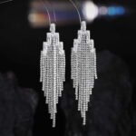 Long tassel CZ fringe drop earrings featuring multi-tier cubic zirconia waterfall chains, baguette crystal top, and 925 sterling silver posts.
