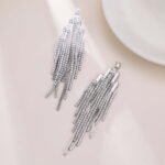 Long tassel CZ fringe drop earrings featuring multi-tier cubic zirconia waterfall chains, baguette crystal top, and 925 sterling silver posts.