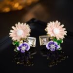 Enamel sunflower garden stud earrings featuring hand-painted enamel petals, green leaves, crystal accents, and 925 sterling silver posts