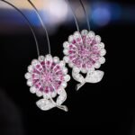 Sparkling CZ sunflower stud earrings wholesale featuring pave-set cubic zirconia flower petals, leafed stems, and 925 sterling silver posts available on junejewelry.com