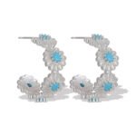 Turquoise CZ flower hoop earrings featuring textured floral blossoms with turquoise centers, micro-paved cubic zirconia, and 925 sterling silver ear posts