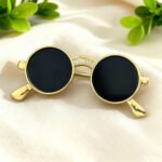 Sunglasses brooch wholesale featuring round black lenses, gold-plated wire frame, and cubic zirconia paved bridge accent from junejewelry.com