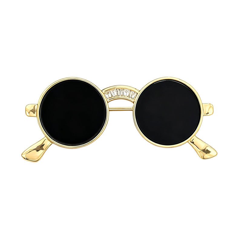Sunglasses brooch wholesale featuring round black lenses, gold-plated wire frame, and cubic zirconia paved bridge accent from junejewelry.com