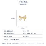 Delicate bow knot shell brooch wholesale featuring pavé cubic zirconia ribbons, inlaid natural mother of pearl shell loops, and a gold-plated finish from junejewelry.com