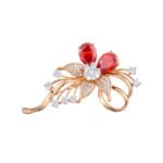 Dazzling rose gold flower brooch wholesale featuring micro-pave cubic zirconia petals, round crystal accents, and pear-cut red crystal gems from junejewelry.com