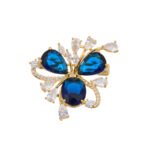 Crystal flower brooch wholesale featuring three prominent teardrop CZ petals surrounded by pavé ribbons and marquise crystal accents in gold plating from junejewelry.com