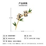 Panda bamboo brooch wholesale featuring two pavé cubic zirconia pandas clinging to a gold-plated bamboo stalk with green enamel leaves from junejewelry.com