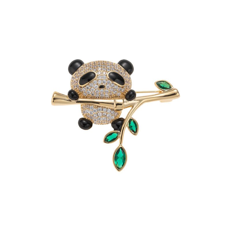 Panda brooch wholesale featuring micro-pavé cubic zirconia panda hugging a gold bamboo stalk with marquise emerald green crystal leaves from junejewelry.com