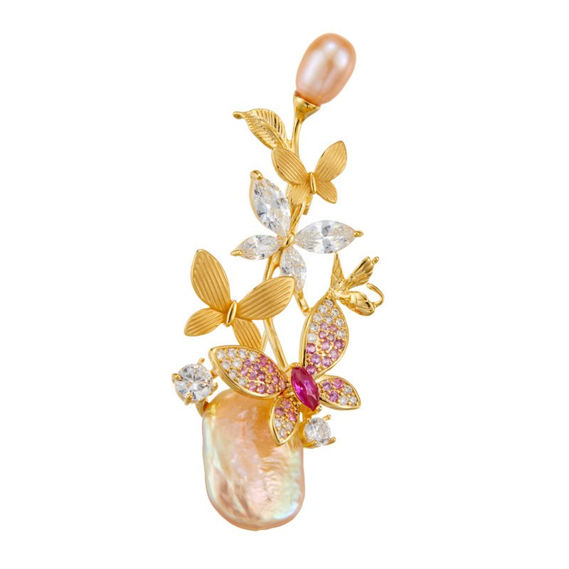 Baroque pearl butterfly brooch wholesale featuring natural baroque freshwater pearls, pavé cubic zirconia butterfly wings, and textured metal accents from junejewelry.com