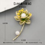 Oriental luxury Chinese style enamel lotus pearl brooch wholesale featuring translucent enamel petals, yellow enamel stamens, micro-pave CZ outlines, and dual freshwater pearls on a gold stem from junejewelry.com