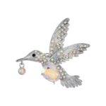 Hummingbird crystal brooch wholesale featuring an iridescent oval AB glass stone center, rainbow rhinestone-paved wings, and a dangling crystal beak charm in silver plating from junejewelry.com