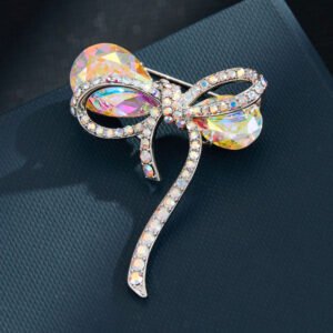 Iridescent bow brooch wholesale featuring faceted rainbow AB glass crystal loops and pave rhinestone ribbon borders in silver plating from junejewelry.com