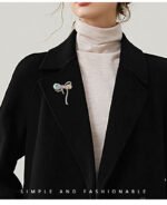 Iridescent bow brooch wholesale featuring faceted rainbow AB glass crystal loops and pave rhinestone ribbon borders in silver plating from junejewelry.com