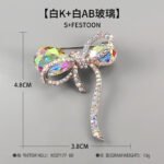Iridescent bow brooch wholesale featuring faceted rainbow AB glass crystal loops and pave rhinestone ribbon borders in silver plating from junejewelry.com