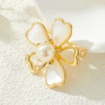Shell flower brooch wholesale featuring five gold-rimmed mother-of-pearl heart petals with a center faux pearl and cubic zirconia accents from junejewelry.com