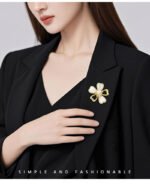 Shell flower brooch wholesale featuring five gold-rimmed mother-of-pearl heart petals with a center faux pearl and cubic zirconia accents from junejewelry.com