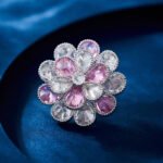 Pink crystal flower brooch wholesale featuring two layers of faceted teardrop cubic zirconia petals in clear and soft pink tones with a textured silver-plated finish from junejewelry.com