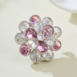 Pink crystal flower brooch wholesale featuring two layers of faceted teardrop cubic zirconia petals in clear and soft pink tones with a textured silver-plated finish from junejewelry.com