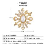 Light luxury unisex nautical pearl star anchor CZ brooch wholesale featuring a large oval pearl centerpiece framed by a starburst of anchors, sea shells, star-cut crystals, and paved cubic zirconia in gold or silver finish from junejewelry.com