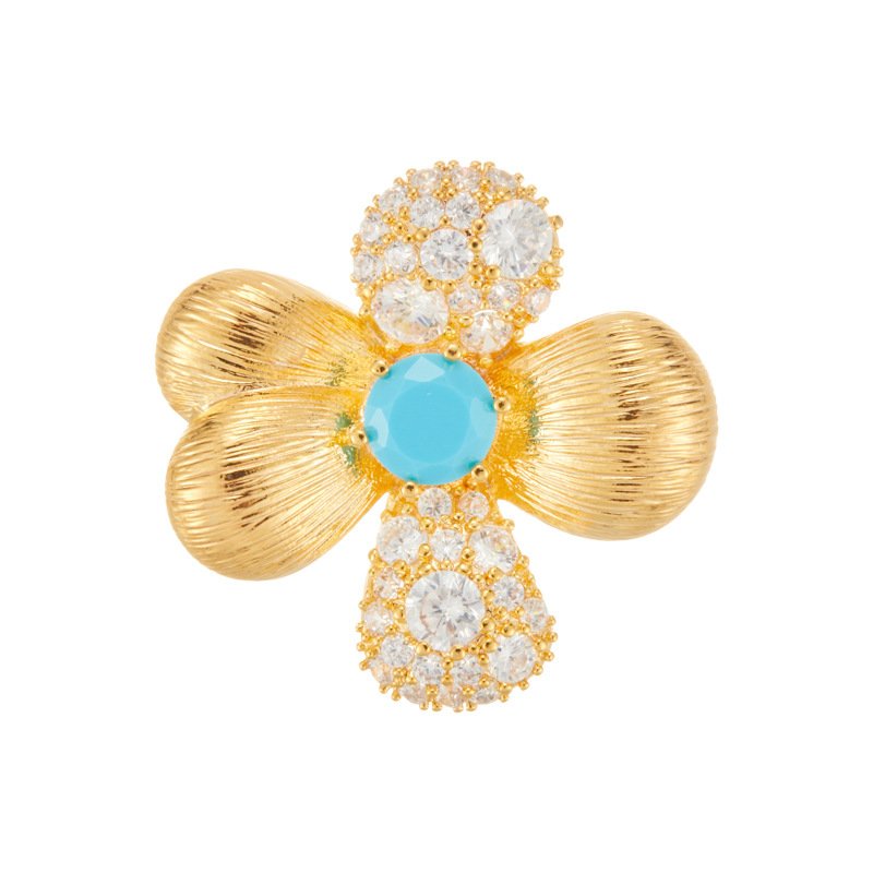 Four petal flower brooch wholesale featuring two brushed gold finish petals, two pavé cubic zirconia petals, and a turquoise stone center in gold plating from junejewelry.com