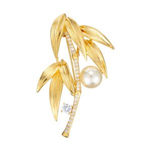 Elegant bamboo leaf pearl brooch wholesale featuring textured metallic leaves, a pavé cubic zirconia curved bamboo stalk, a sparkling solitaire round CZ accent, and a glossy pearl drop from junejewelry.com