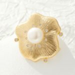 Vintage brushed gold pearl flower brooch wholesale featuring a textured wire-brushed gold flower petal design, central white pearl, and embedded cubic zirconia accents from junejewelry.com