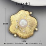 Vintage brushed gold pearl flower brooch wholesale featuring a textured wire-brushed gold flower petal design, central white pearl, and embedded cubic zirconia accents from junejewelry.com