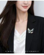 Elegant magnetic mother of pearl butterfly brooch wholesale featuring natural white or black shell wings, micro-pave cubic zirconia body, and a fabric-safe pinless magnetic back clasp from junejewelry.com