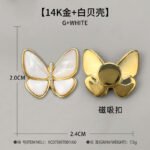 Elegant magnetic mother of pearl butterfly brooch wholesale featuring natural white or black shell wings, micro-pave cubic zirconia body, and a fabric-safe pinless magnetic back clasp from junejewelry.com