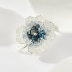 Elegant magnetic four leaf clover crystal brooch wholesale featuring four clover petals filled with crushed ice crystals and bi-color center accents, with a pinless magnetic back clasp from junejewelry.com