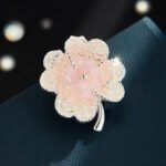 Elegant magnetic four leaf clover crystal brooch wholesale featuring four clover petals filled with crushed ice crystals and bi-color center accents, with a pinless magnetic back clasp from junejewelry.com