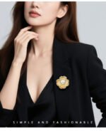 Pearl flower brooch wholesale featuring five brushed gold textured petals trimmed with micro-pavé cubic zirconia and a large center faux pearl from junejewelry.com