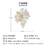 High-end baroque pearl flower CZ brooch wholesale featuring iridescent teardrop baroque shell petals, brilliant pear and marquise cubic zirconia stones, and detailed central stamens from junejewelry.com