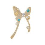 Pearl turquoise butterfly brooch wholesale featuring micro-pavé cubic zirconia wings studded with round pearls and round turquoise cabochons from junejewelry.com