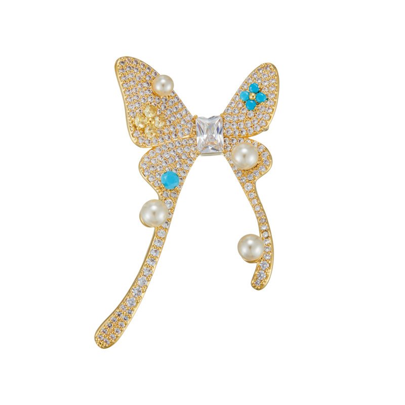 Pearl turquoise butterfly brooch wholesale featuring micro-pavé cubic zirconia wings studded with round pearls and round turquoise cabochons from junejewelry.com