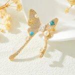 Pearl turquoise butterfly brooch wholesale featuring micro-pavé cubic zirconia wings studded with round pearls and round turquoise cabochons from junejewelry.com