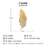 Elegant gold feather brooch wholesale featuring a brushed matte gold vane contrasted with a sparkling micro-pave cubic zirconia lower plume from junejewelry.com