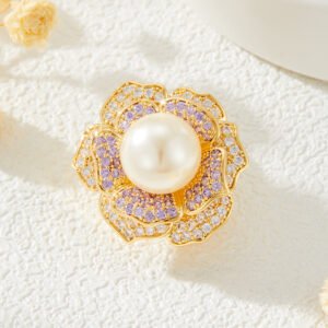 High-end magnetic camellia CZ pearl brooch wholesale featuring micro-pave white and purple cubic zirconia petals, a luminous glass pearl center, and a strong pinless magnetic back clasp in gold or rhodium finish from junejewelry.com