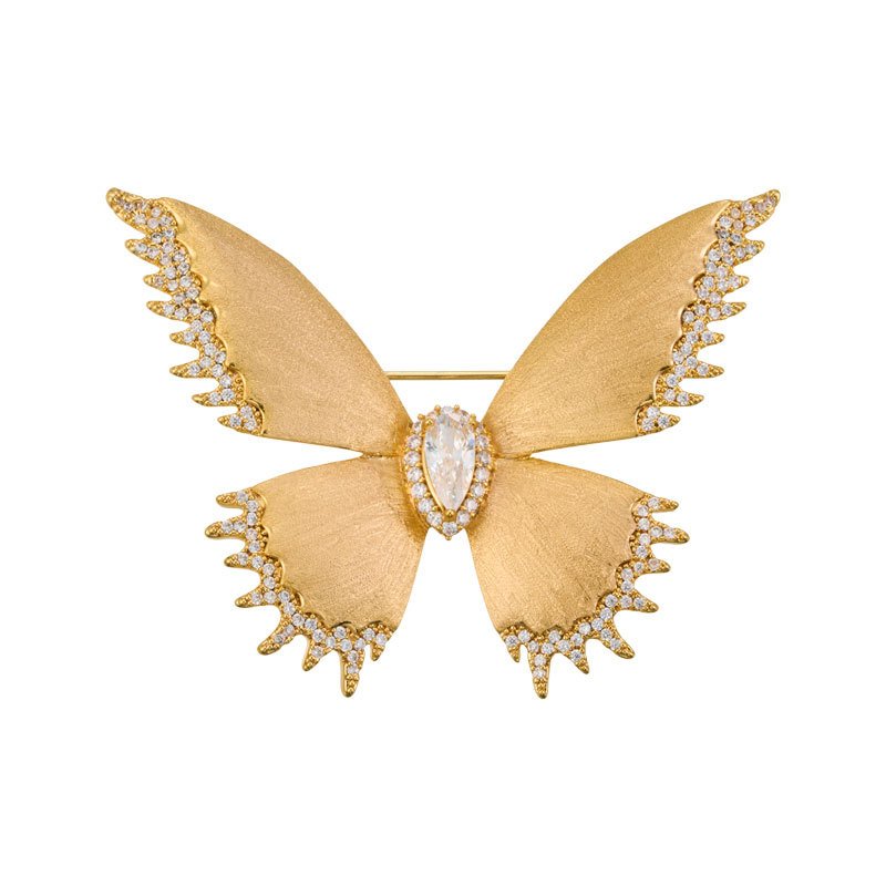 Brushed gold butterfly brooch wholesale featuring textured matte wings with cubic zirconia paved edges and a teardrop center stone from junejewelry.com