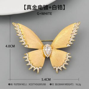 Brushed gold butterfly brooch wholesale featuring textured matte wings with cubic zirconia paved edges and a teardrop center stone from junejewelry.com