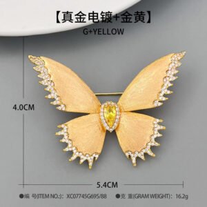 Brushed gold butterfly brooch wholesale featuring textured matte wings with cubic zirconia paved edges and a teardrop center stone from junejewelry.com