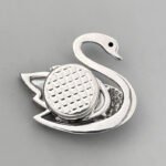 Elegant mother of pearl swan brooch wholesale featuring a carved natural shell wing, pavé cubic zirconia feathers, a black CZ eye, and a magnetic closure from junejewelry.com